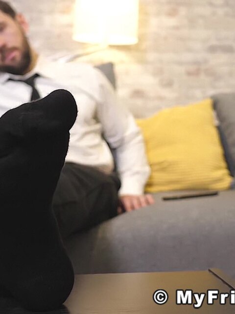Alexander strips off his business attire to reveal his bare feet
