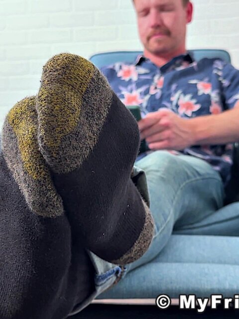 Russ takes off his shoes and socks to display his delectable feet
