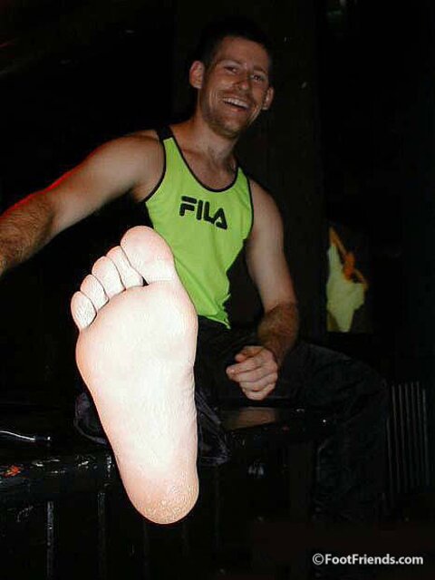 Robert greets men at the door while showing off his sexy bare feet