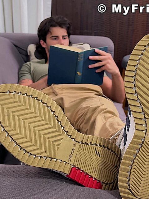 Zeke Stone props his size 10 feet while reading