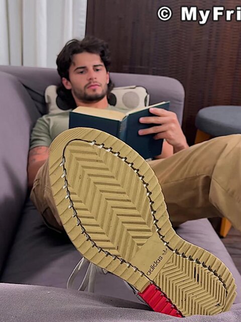 Zeke Stone props his size 10 feet while reading