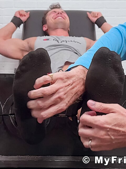 Dan Edwards tickles Travis Maverick’s feet and he laughs