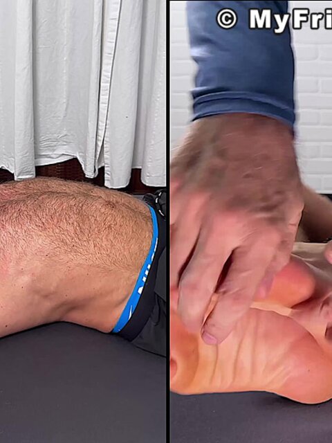 Daniel squirms as Dan Edwards tickles his bare feet