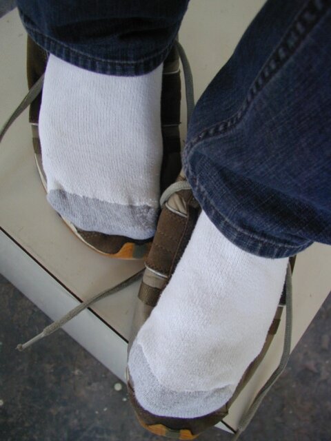 Sebastian shows his sweaty white socks after gym