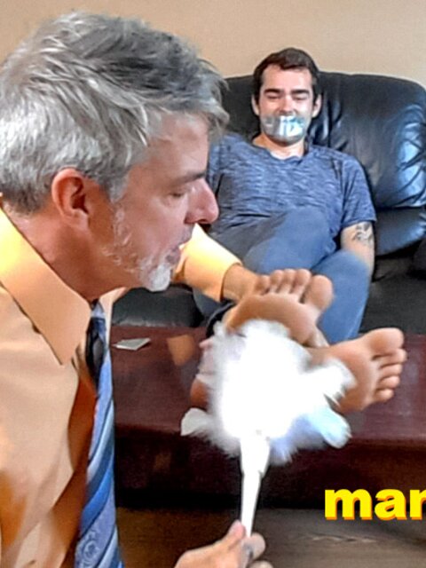 Kody Tracer squirms as Richard Lennox tickles with brush