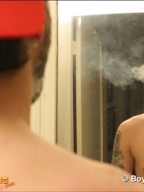Zack smokes a cigarette while shaving in bathroom
