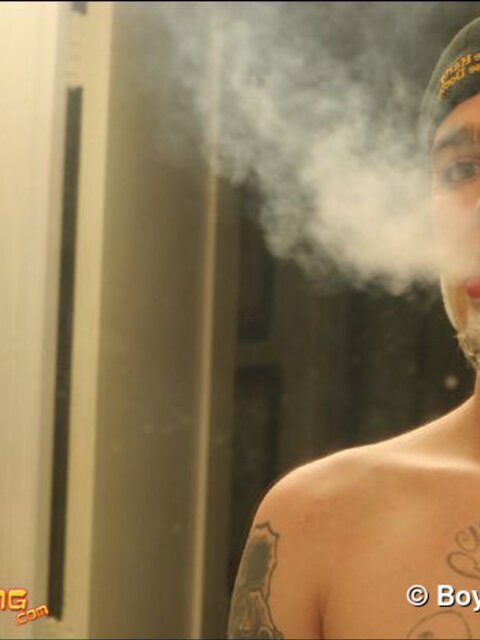 Zack smokes a cigarette while shaving in bathroom