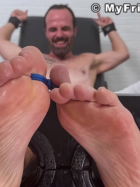 Chris squirms as Dan Edwards tickles his upper body