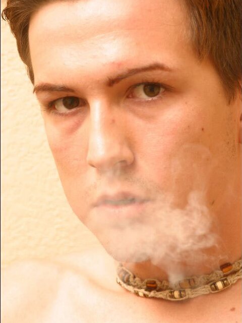 Joshua strips and strokes his cock while smoking