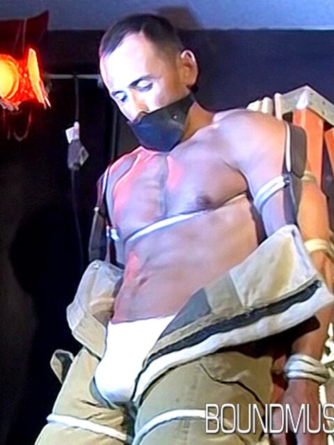Duke Rivers is gagged and bound, showing off his big body
