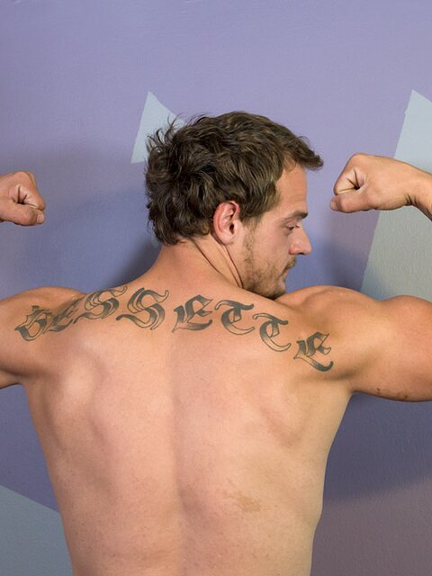Muscular and tattooed, Jimmy Longdong strokes his cock in the bedroom