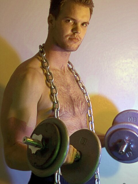 Billy Club teases with sexy poses and soft lighting in a hot gym shoot