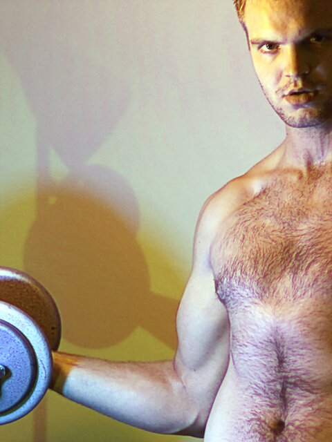 Billy Club teases with sexy poses and soft lighting in a hot gym shoot