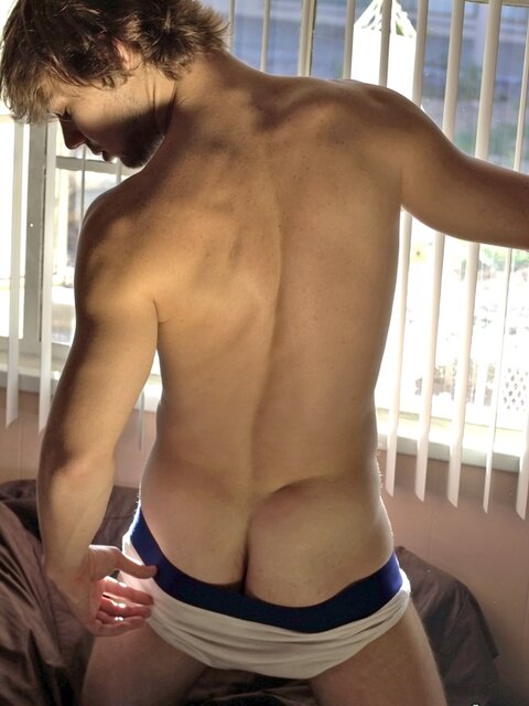 Stroking Zack Randall shoots cum from his hooded dick