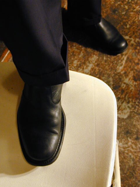 Eric’s slim feet and sheer dark socks steal the show