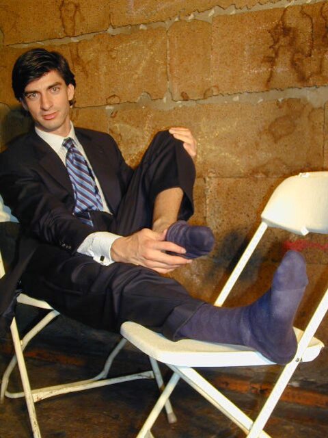Eric’s slim feet and sheer dark socks steal the show