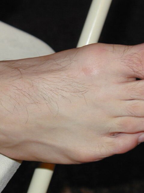 Eric’s slim feet and sheer dark socks steal the show