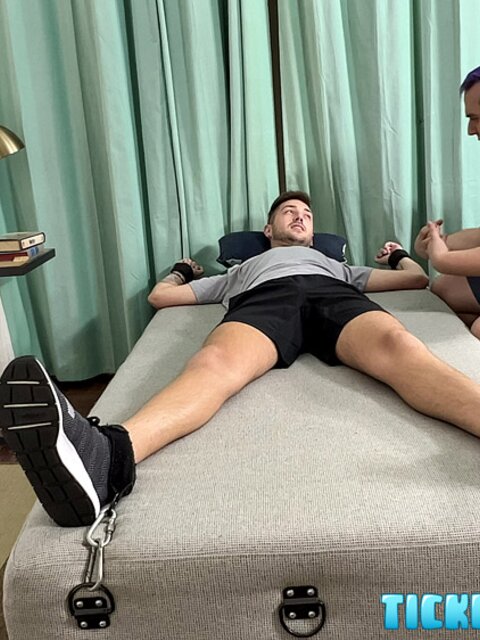 Dimitri laughs hard as Matt tickles his bare feet after gym class