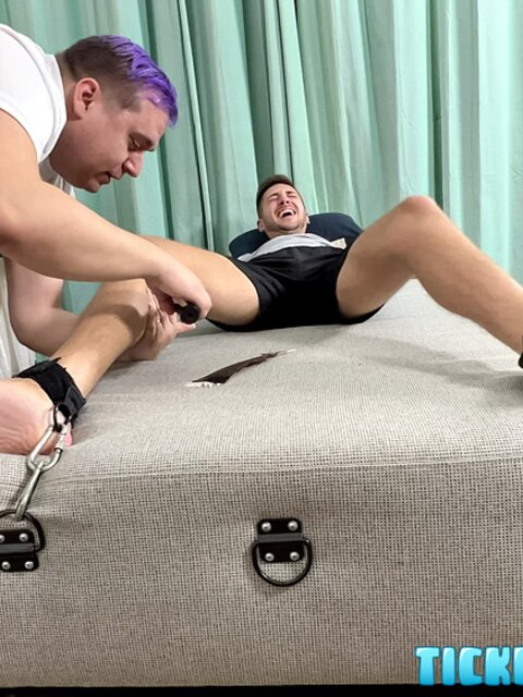Dimitri laughs hard as Matt tickles his bare feet after gym class