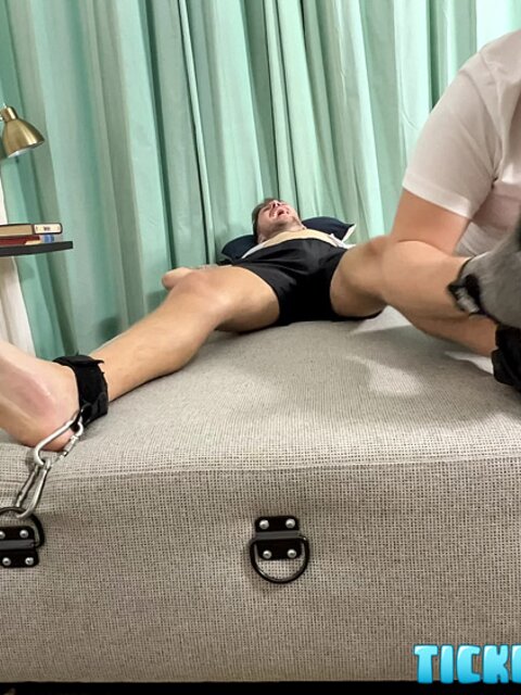 Dimitri laughs hard as Matt tickles his bare feet after gym class