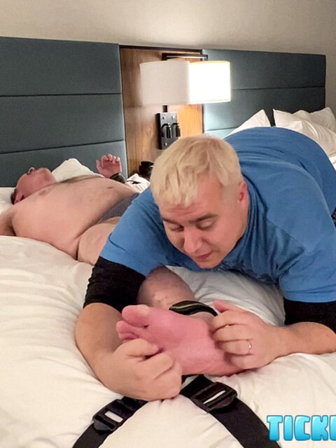 Matt tickles Wes’s feet in hotel bedroom