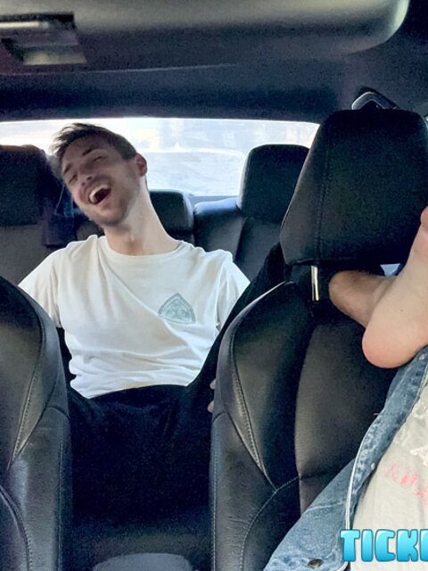 Dimitri giggles as Ryder and Matt tickle his propped-up feet