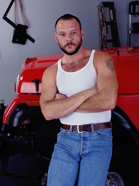 Hairy trucker bear stuffs a massive black dildo deep in his ass at the truck stop