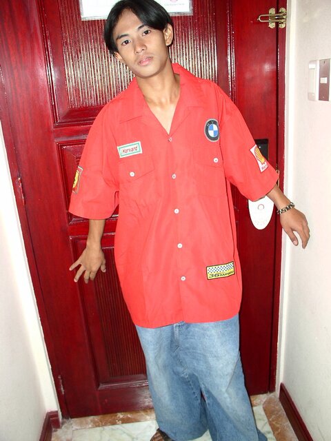 Cute young twink Bhoby strips out of his red shirt and baggy jeans