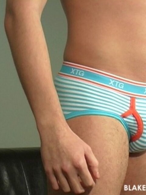 Shy Zach G lubes up his eight inch uncut cock for a hot couch session