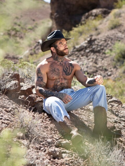 Cowboy Joel Hart drives into Sage Rouxe against the desert truck bed